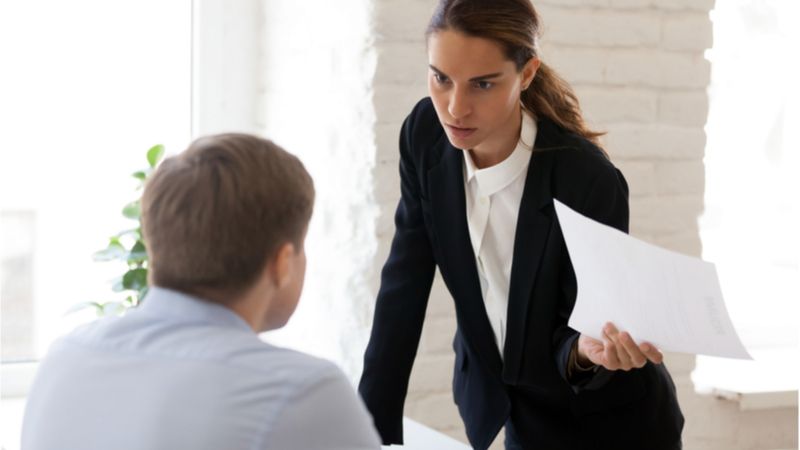 businesswoman blaming employee for mistake
